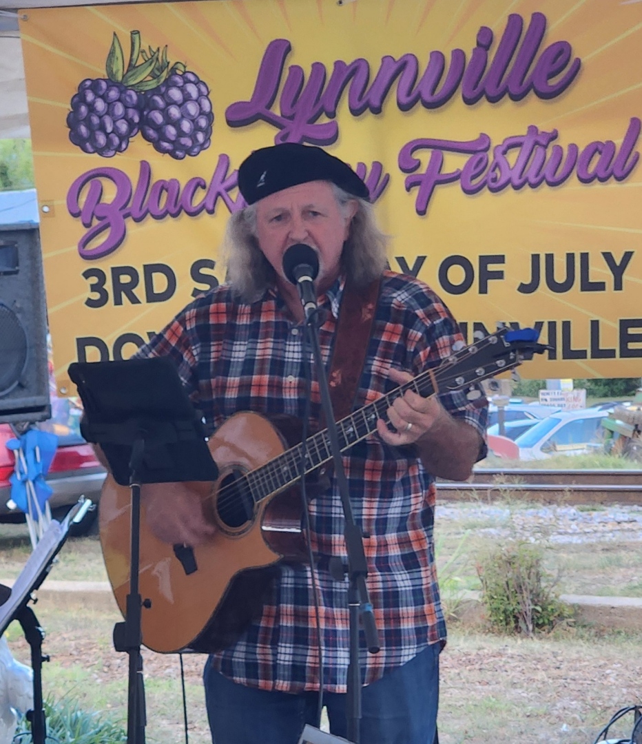 Picture in front of Lynnville Blackberry Festival banner